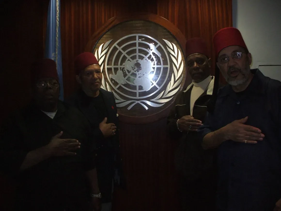 Group portrait in front of United Nations emblem