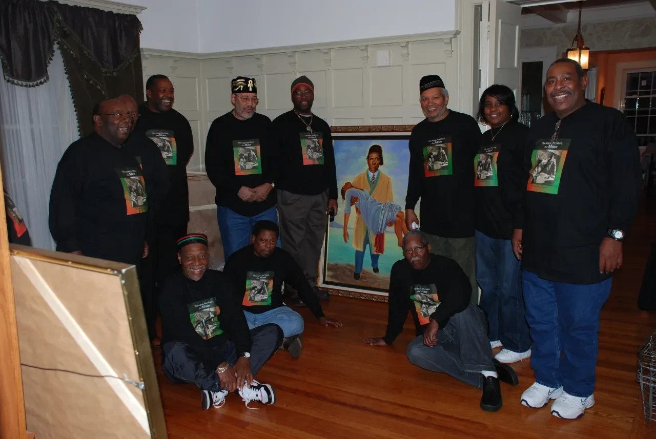 Group gathered around a framed portrait artwork
