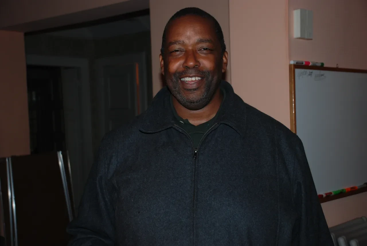 Smiling man photographed indoors