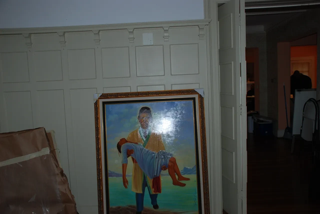 Framed painting in a paneled room