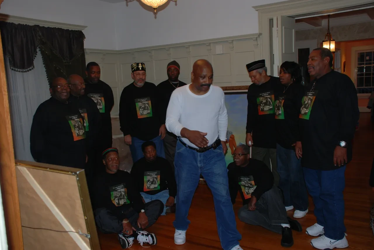 Indoor gathering around a framed portrait